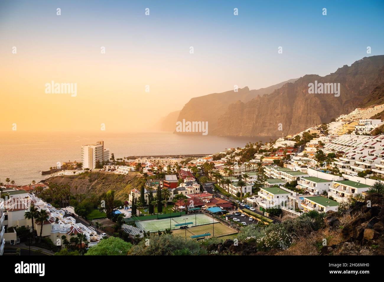 Los Gigantes resort town on Tenerife at sunset. Giant rock formations Acantilados de Los Gigantes as beautiful tourist destination on Canary Islands Stock Photo