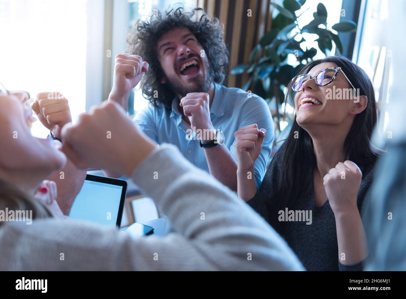 Successful young creative business team celebrating their success Stock ...