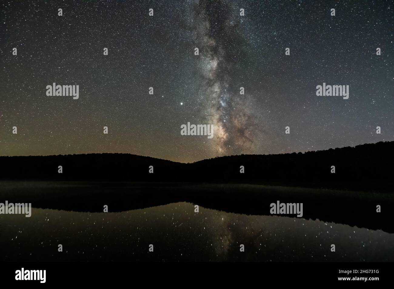 Night dark sky with milky way in Spruce Knob Lake West Virginia water
