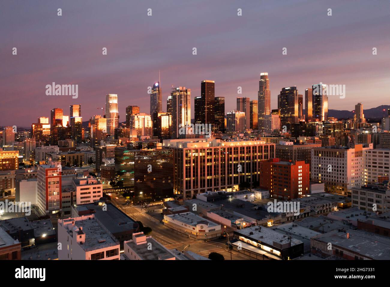 Pre-dawn aerial view of the downtown Los Angeles skyline with colorful sunrise approaching Stock Photo