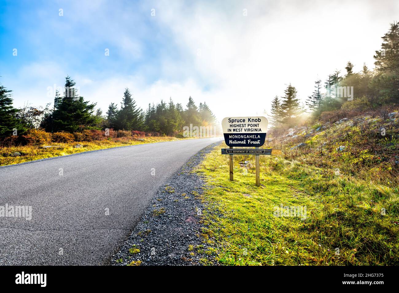 Spruce Knob West Virginia mist fog autumn fall season and sign on empty road in morning for highest point in Monongahela national forest Appalachian A Stock Photo