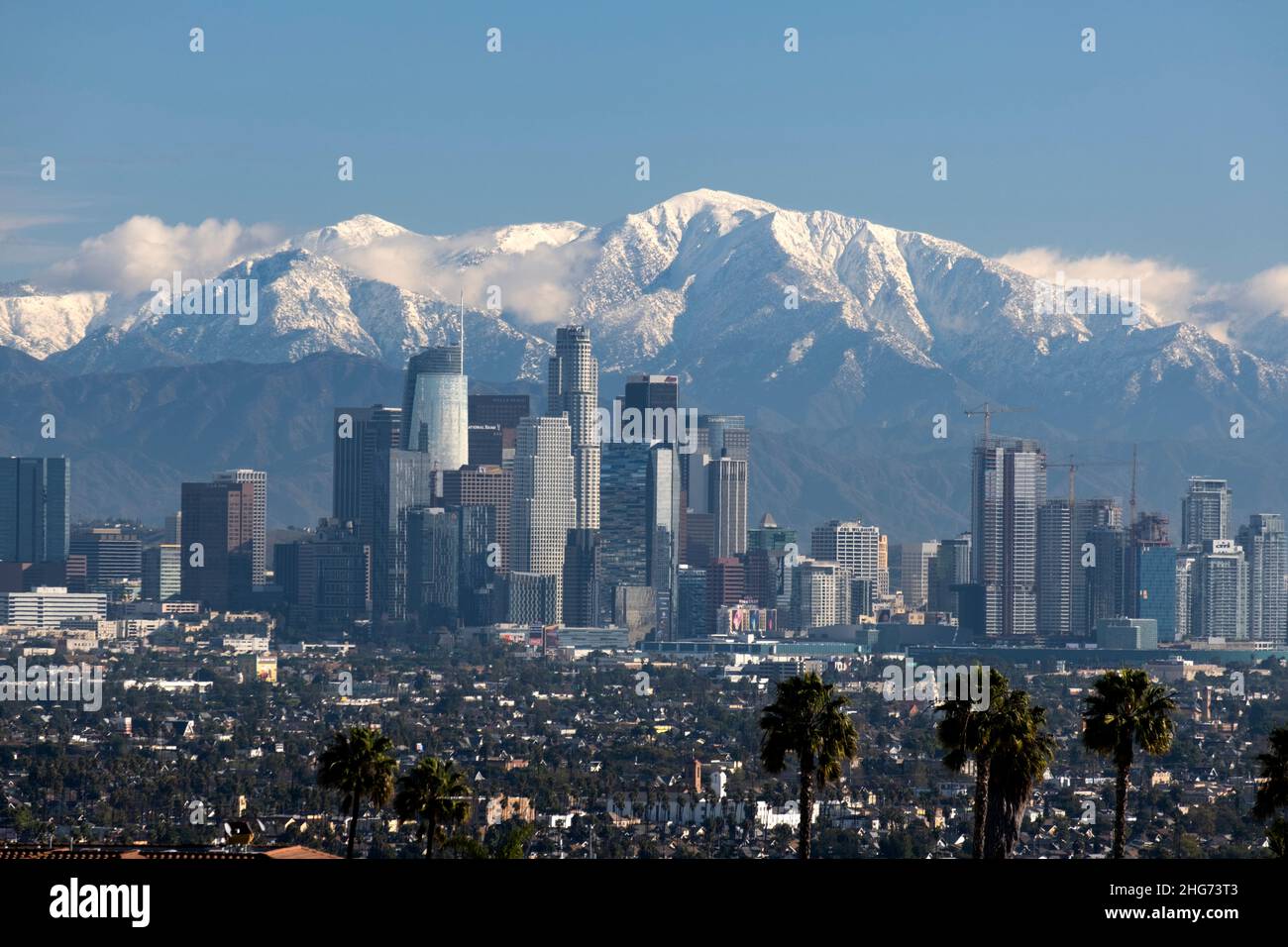 Skyline of downtown Los Angeles on a clear day with the San Gabriel Mountains and Mt. Baldy covered in snow Stock Photo