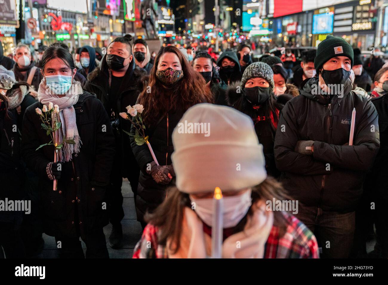 People attend a candlelight vigil for Michelle Go, who was killed after