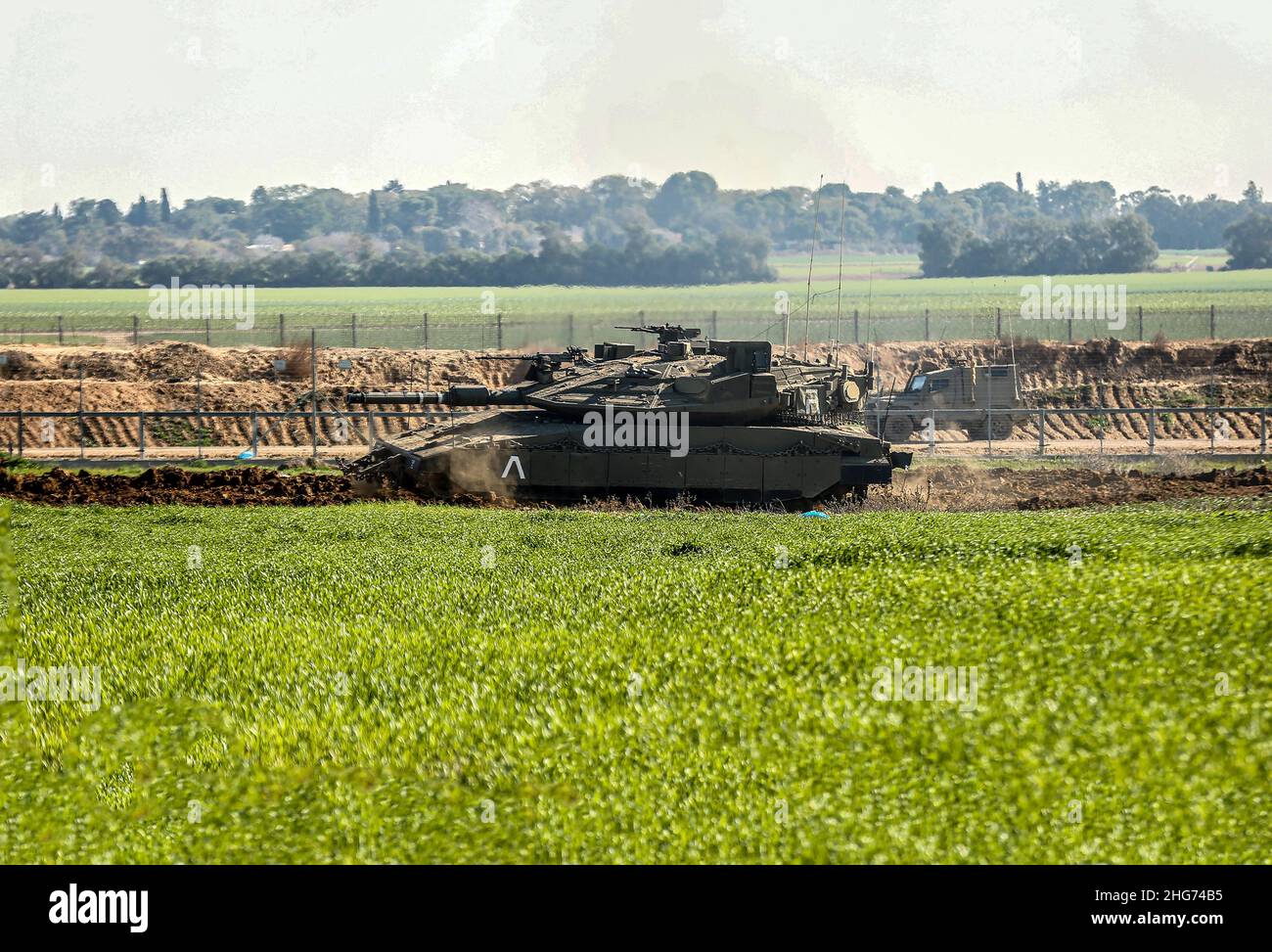 Gaza, Palestine. 18th Jan, 2022. An Israeli military tank was seen driving inside the Palestinian territories at the border in Khuza'a, east of Khan Yunis, south of the Gaza Strip. (Photo by Yousef Masoud/SOPA Images/Sipa USA) Credit: Sipa USA/Alamy Live News Stock Photo