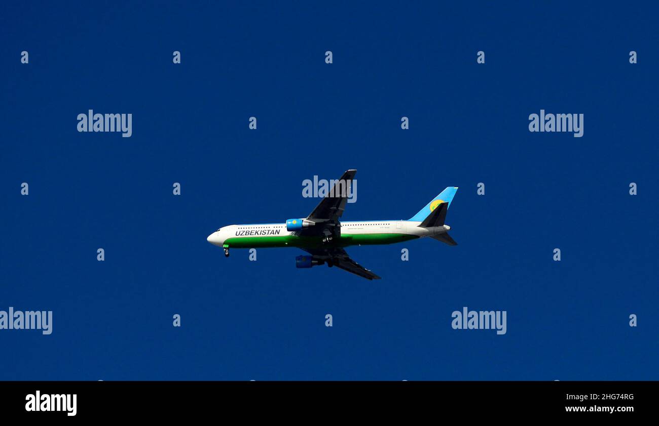 An Uzbekistan Airways airplane flying over Istanbul, Turkey. Stock Photo