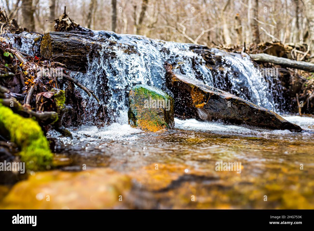 Small waterfall river stream water flowing in Shamokin Springs Nature preserve hiking trail in Wintergreen Resort in Virginia closeup low angle ground Stock Photo