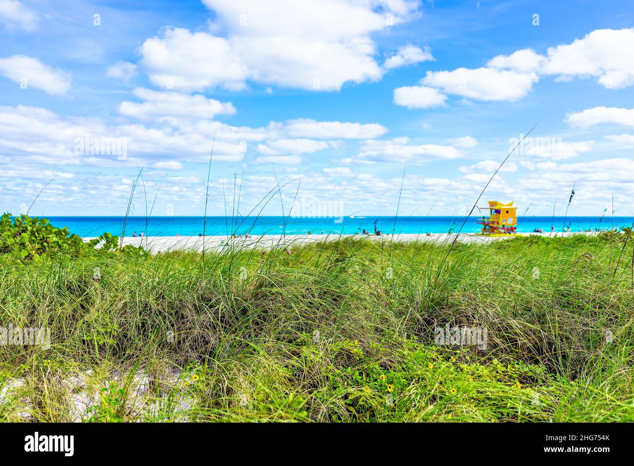 Miami South Beach lifeguard building along ocean coast sunny blue sky clouds in Florida day with people in background by turquoise colorful water colo Stock Photo