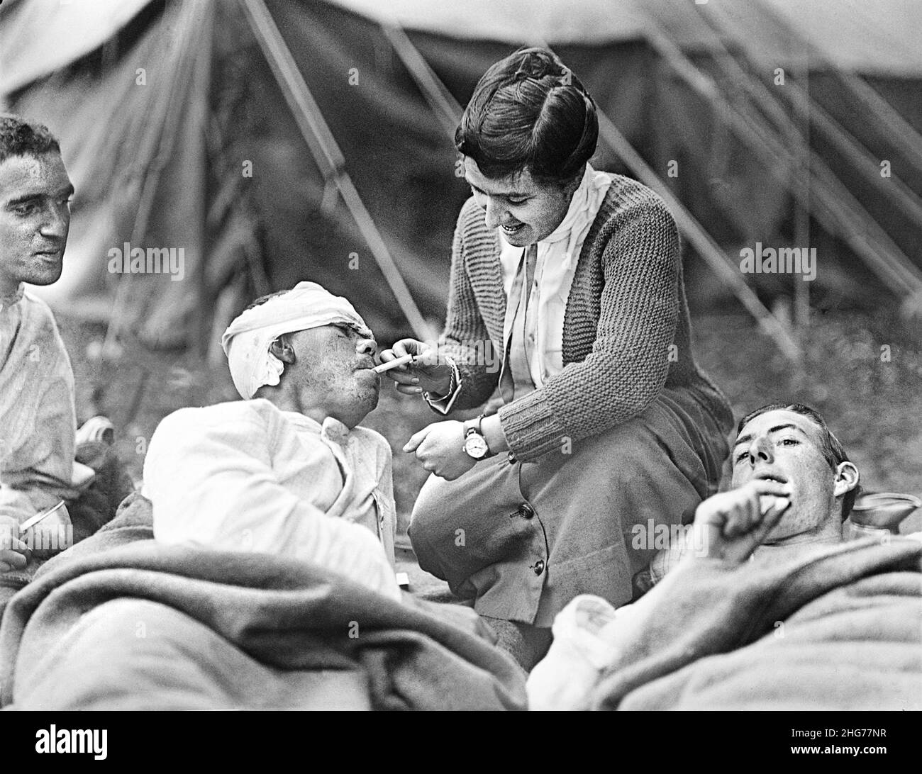 Miss Anna Rochester of Buffalo, New York, USA, lighting Cigarette for Private Ernest Stanback, of 165th Infantry, Co. E., 42nd Division, American Red Cross Hospitals #6 & #7, Souilly, France, American National Red Cross Photograph Collection, March 12, 1919 Stock Photo