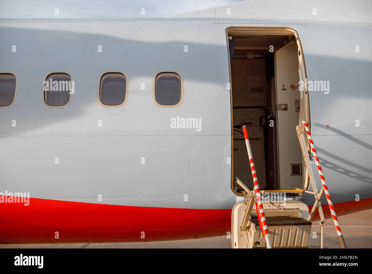 Passenger airplane with open entrance door at airport Stock Photo Alamy
