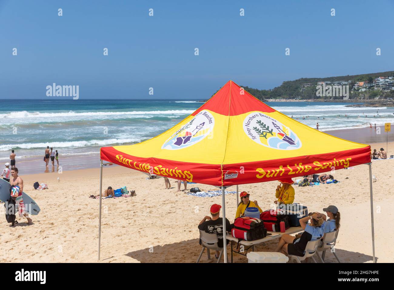 Surf life saving team of volunteers and council lifeguards on Manly Beach Sydney in summer and taking shade under the tent,Sydney,Australia Stock Photo