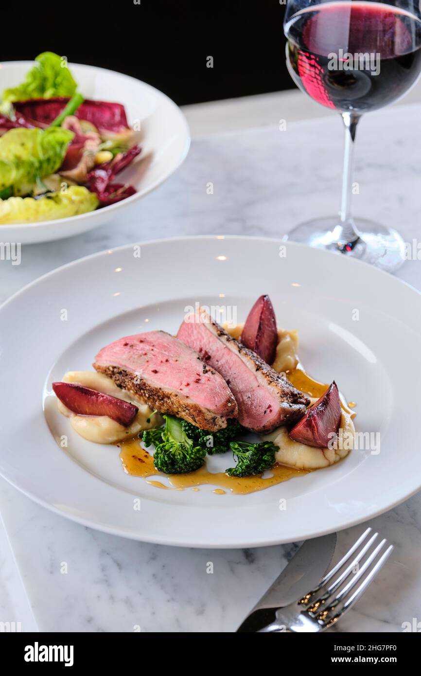 Summer duck with roasted plumb and sherry with red wine. Stock Photo