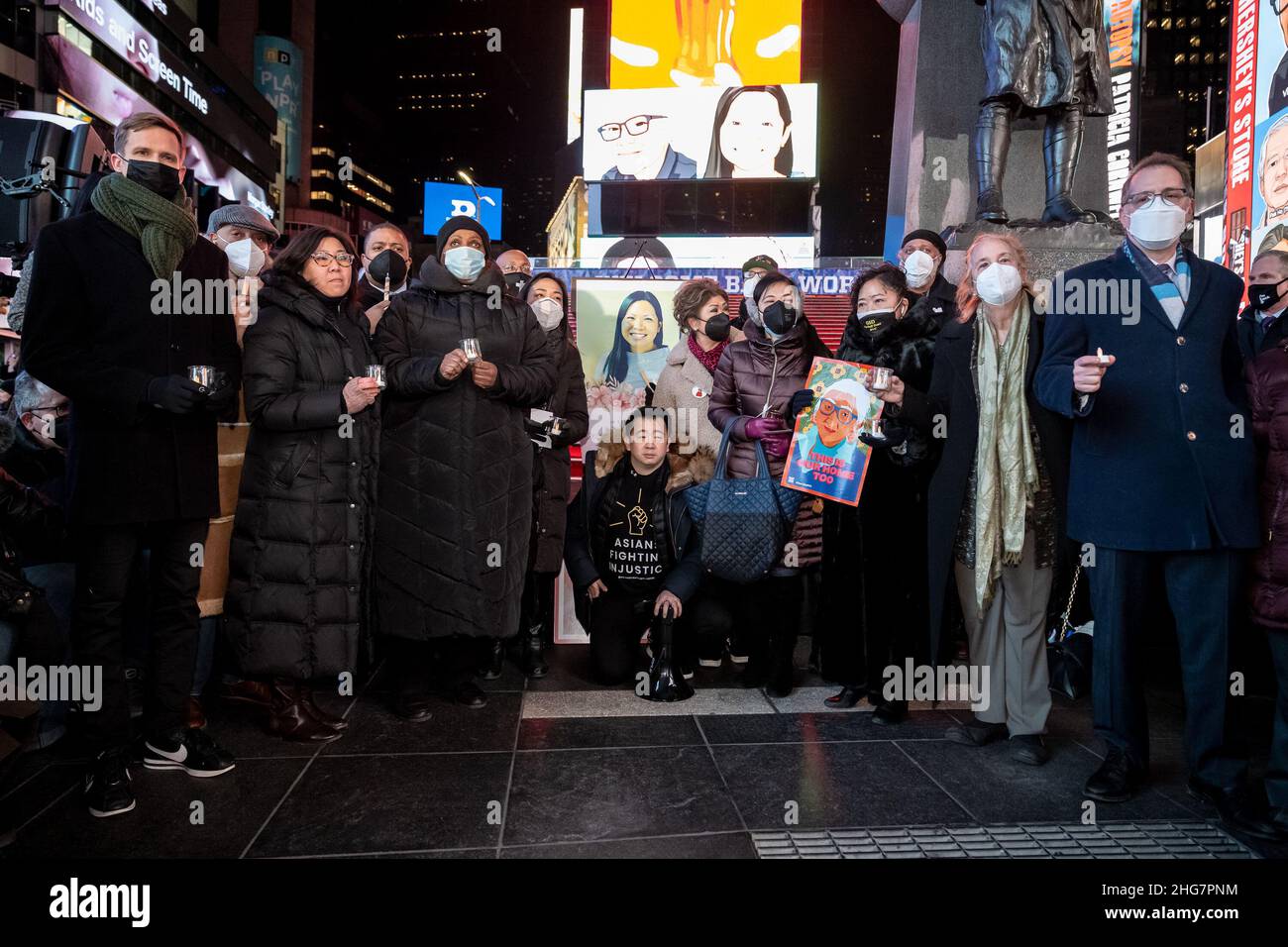 Community activists and elected officials attend a candlelight vigil