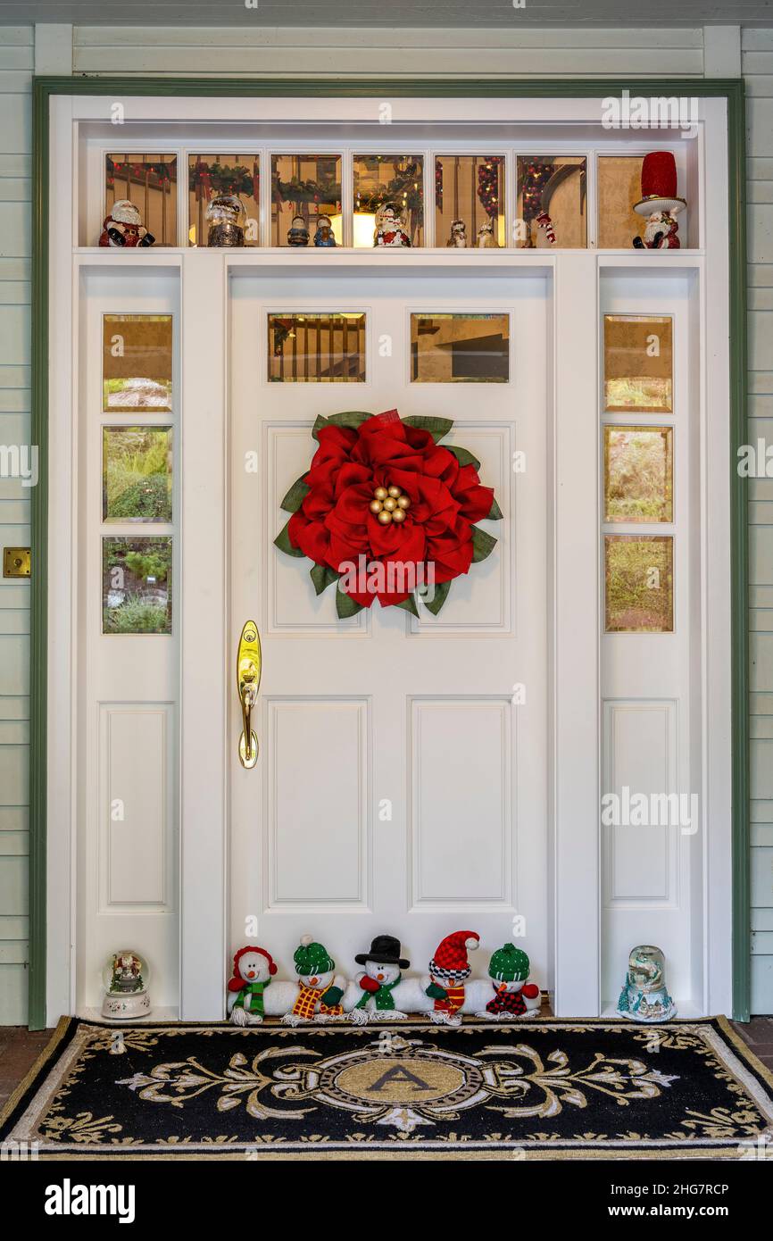 House door decorated with Christmas garland Stock Photo