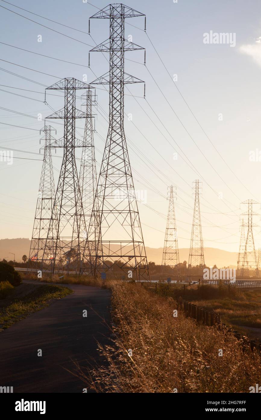 Group of Electricity Pylons at Bike Path in Evening, CA, US Stock Photo