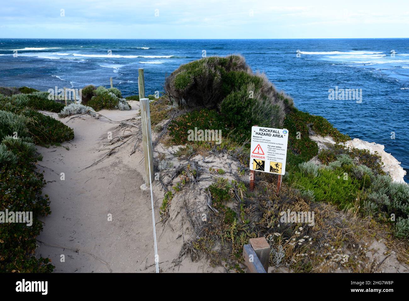 Signs warning of 'Rockfall Hazard Area' on cliffs overlooking Gnarabup Beach, Gnarabup, Western Australia Stock Photo