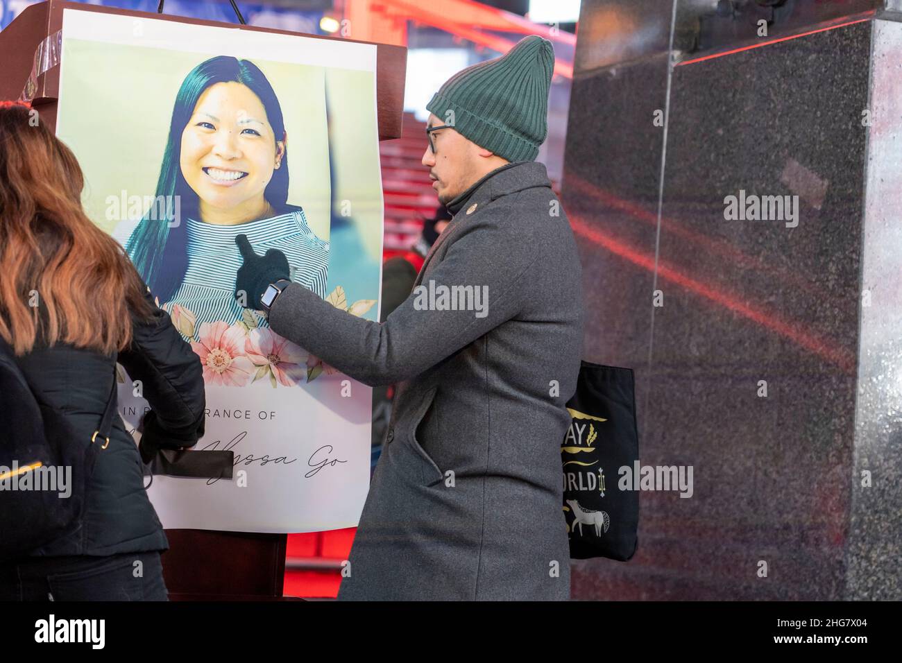 Organizers post a poster with a picture of Michelle Alyssa Go at a