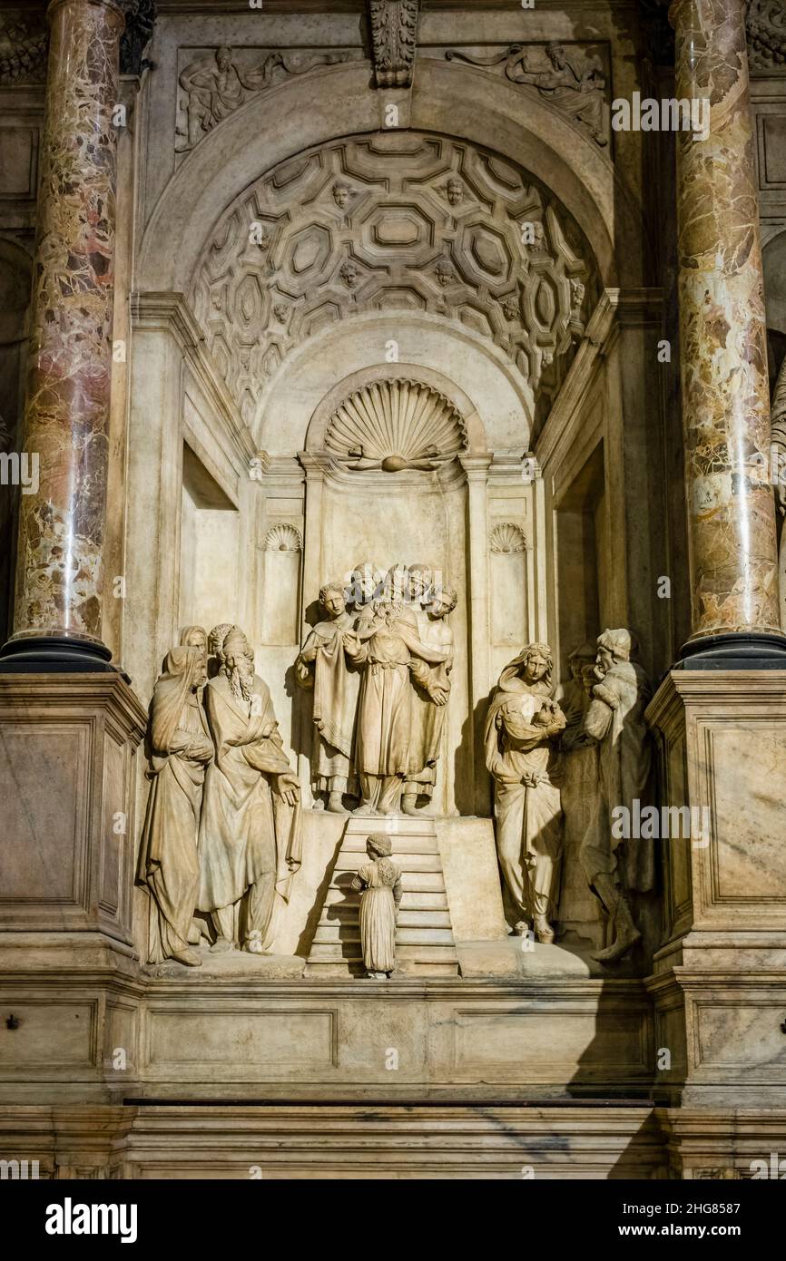 A detail inside the Milan Cathedral, Duomo di Milano, with marble columns and magnificent statues. Stock Photo