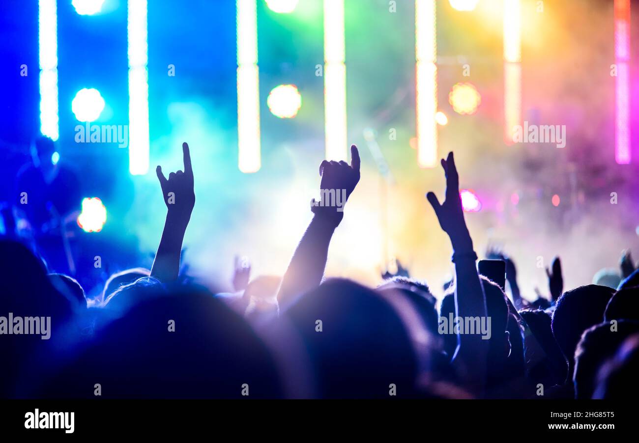 crowd at concert, music festival with silhouettes of the audience Stock Photo