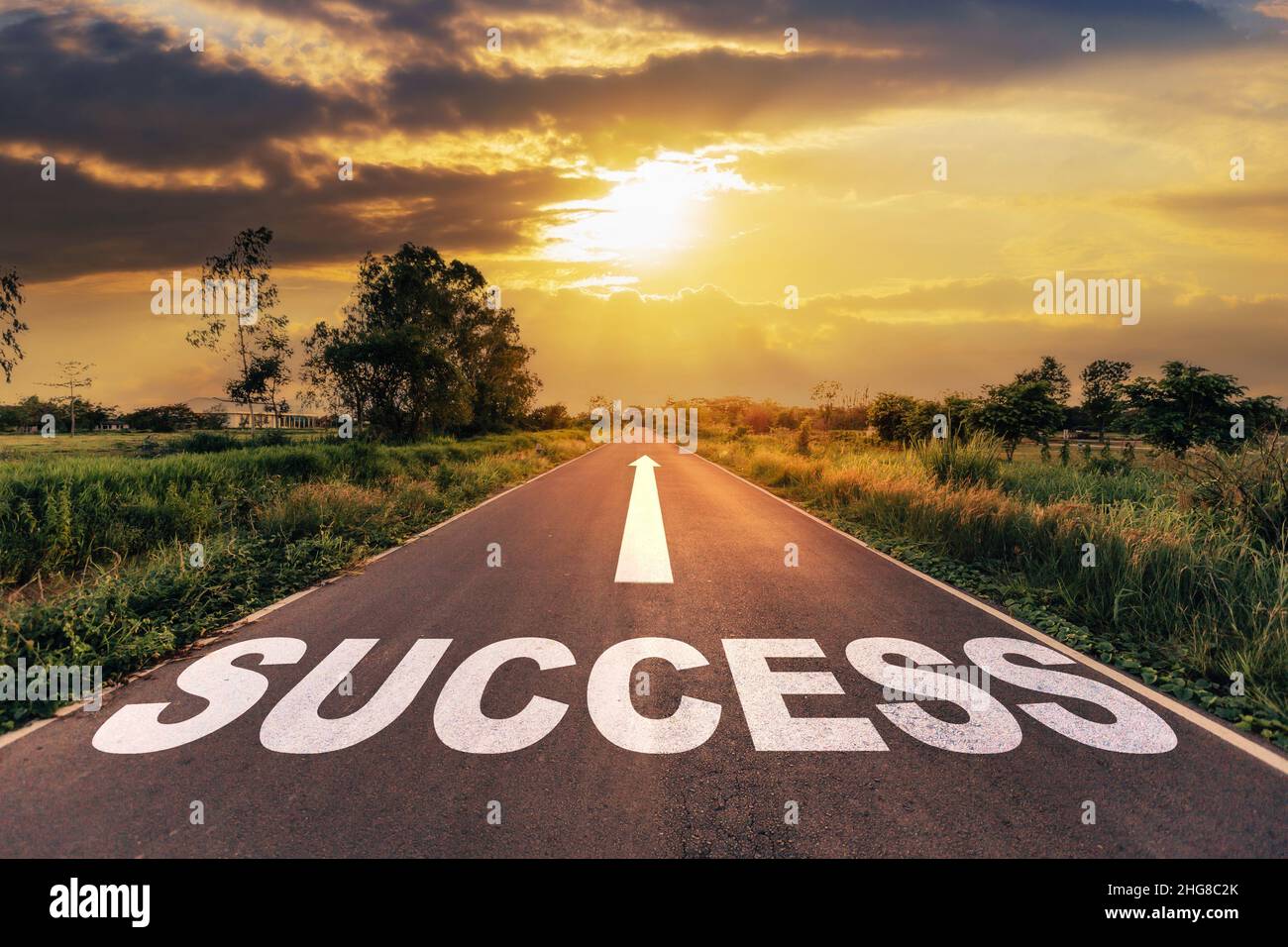 Success text on the highway road concept for planning and challenge or career path, business strategy in sunset background. Stock Photo