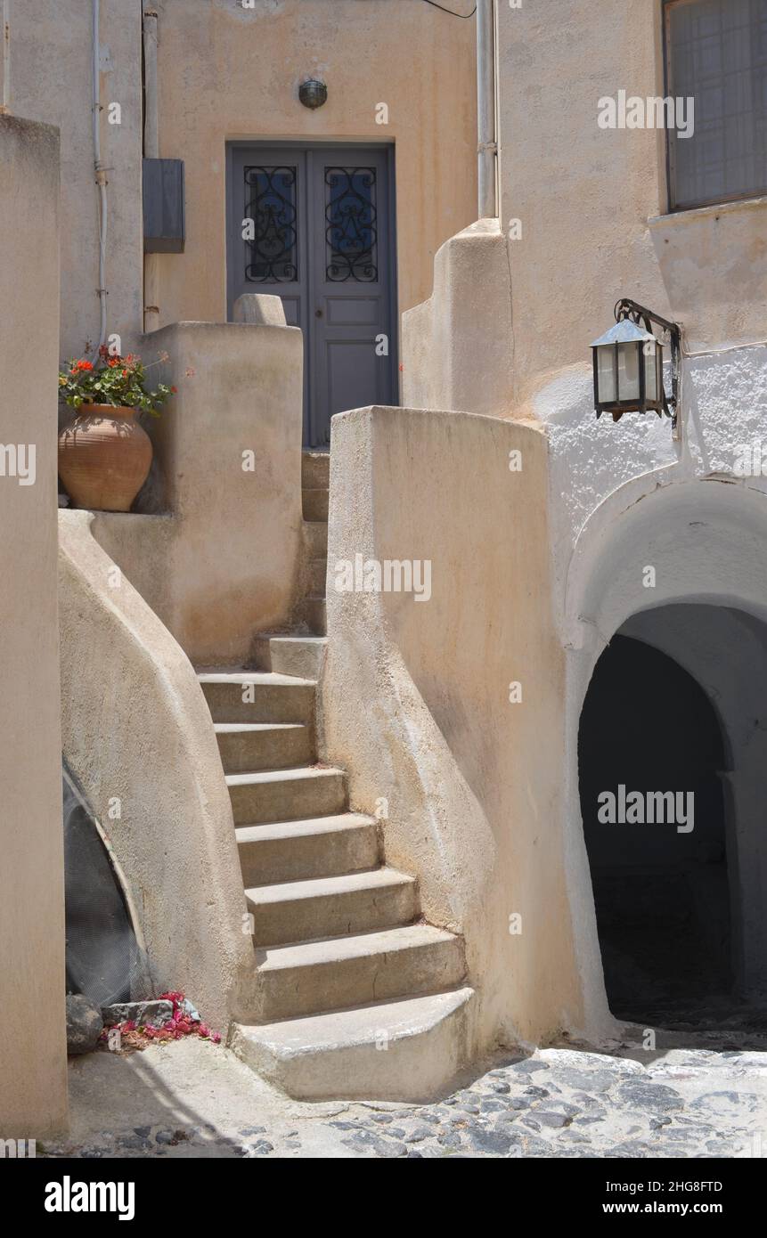 Facade of a beautiful home with white creamy walls in Pyrgos, old village of Santorini, Thira, Greece Stock Photo