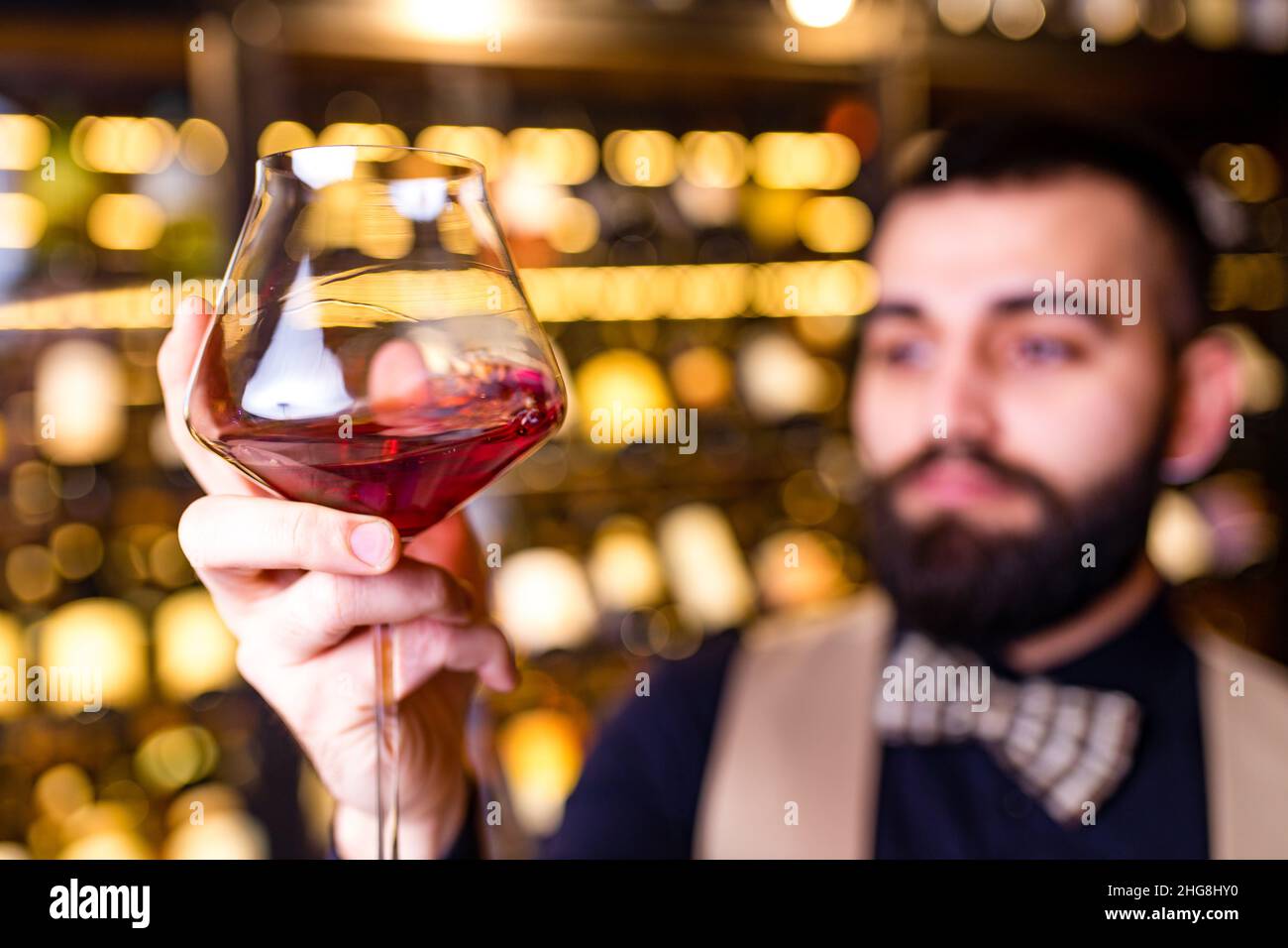 arabian man sommelier appreciating drink in lux hotel Stock Photo