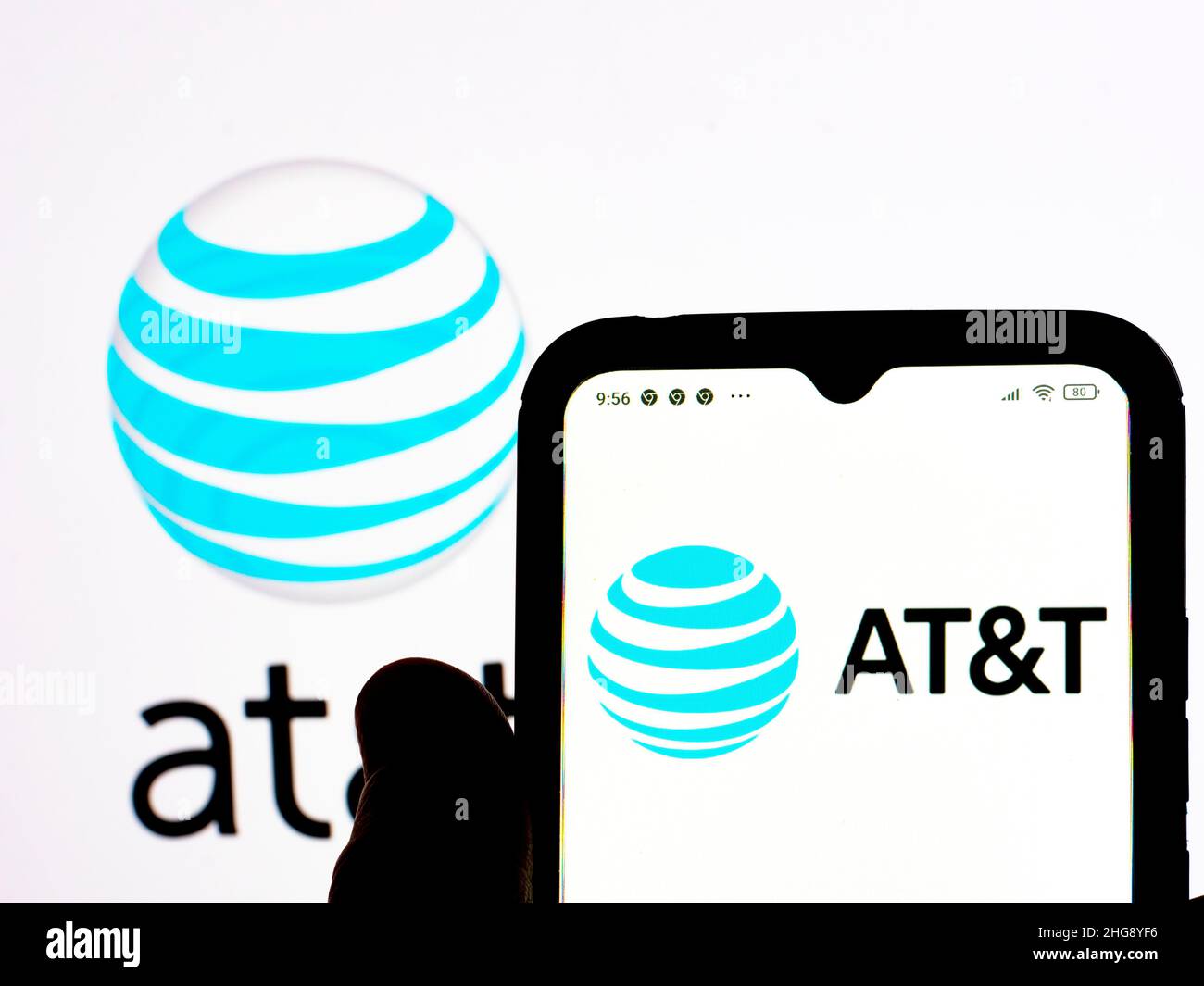 In this photo illustration, the AT&T logo is seen displayed on a ...