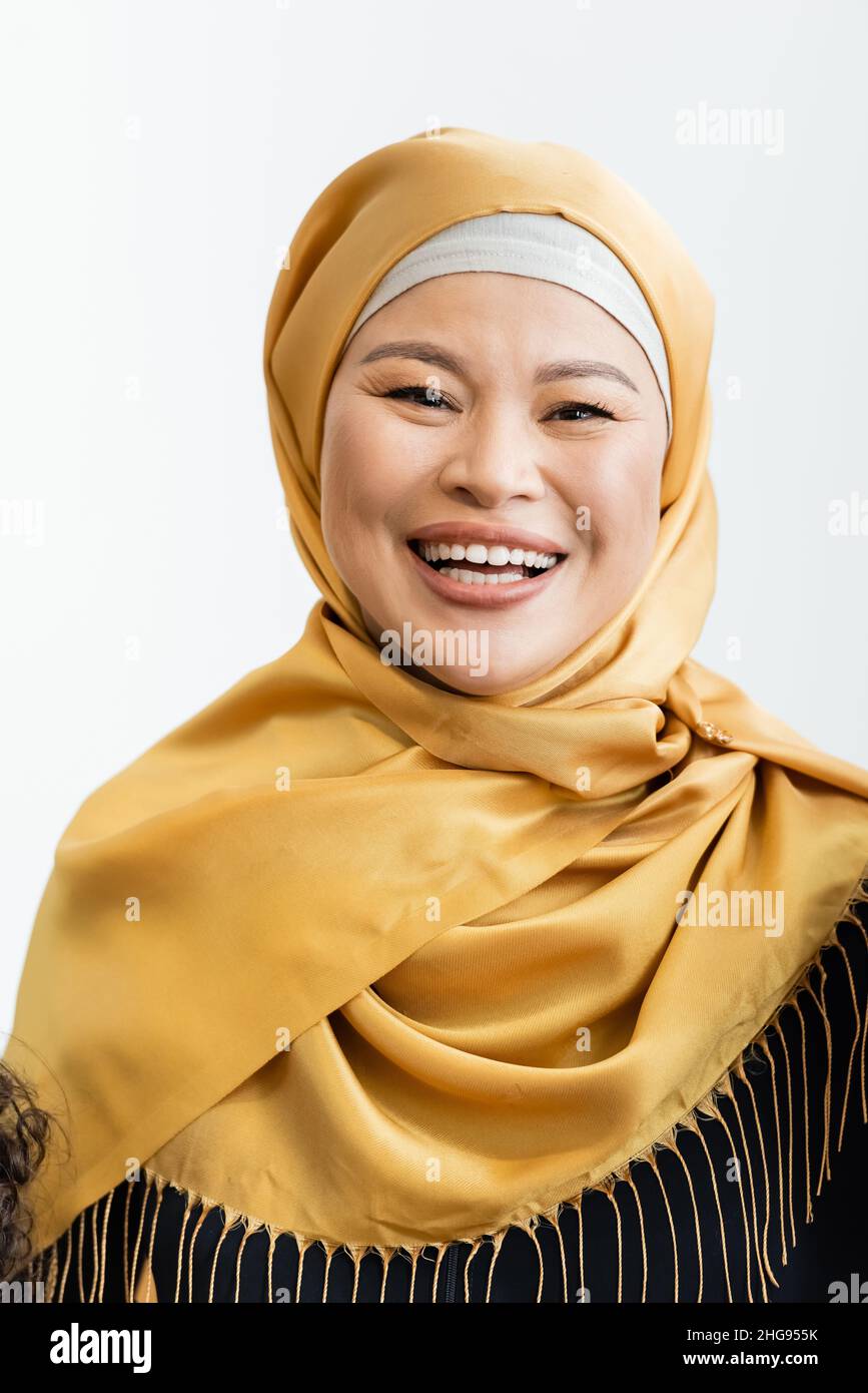 happy asian muslim woman in hijab smiling at camera isolated on white Stock Photo