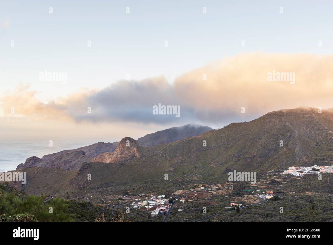 Dawn light and cloud over the los Gigantes cliffs and the Santiago valley villages of El Molledo and Santiago del Teide, Tenerife, Canary Islands, Spa Stock Photo