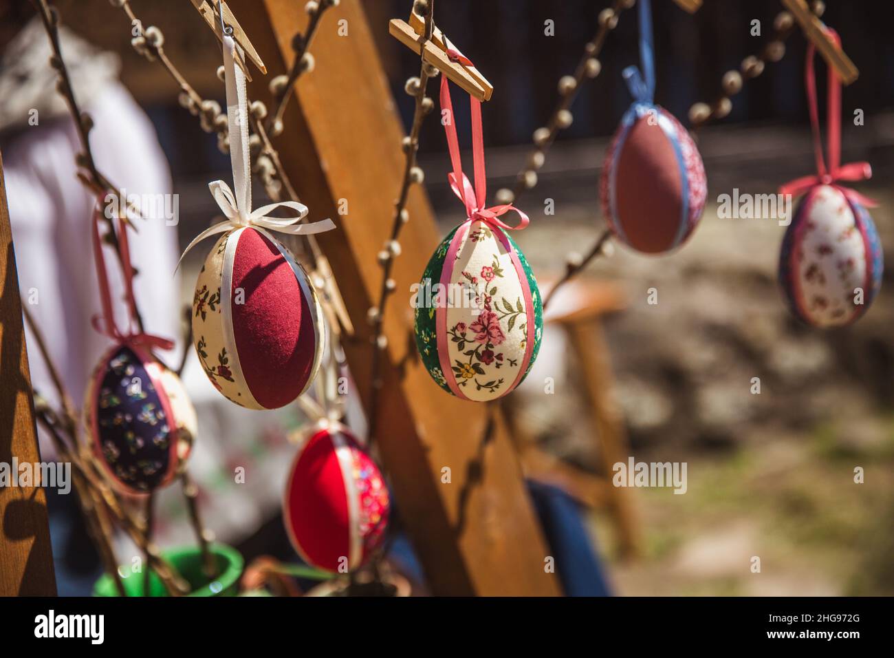 HOLLOKO, HUNGARY - April 12, 2019: Decorative Easter eggs and colored ribbons hanging on tree, Easter celebration Stock Photo