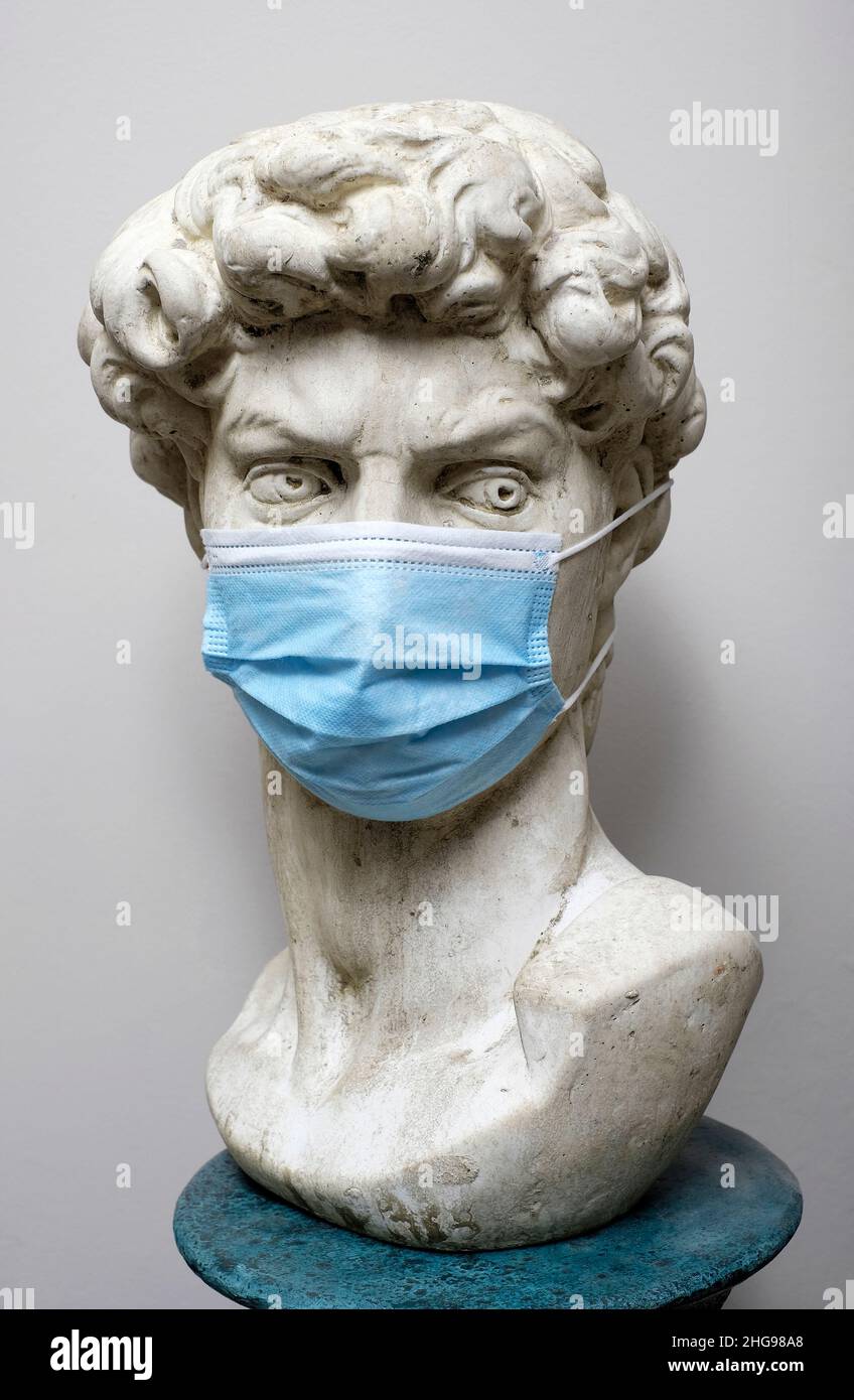 bust of michelangelo's david wearing face covering mask Stock Photo