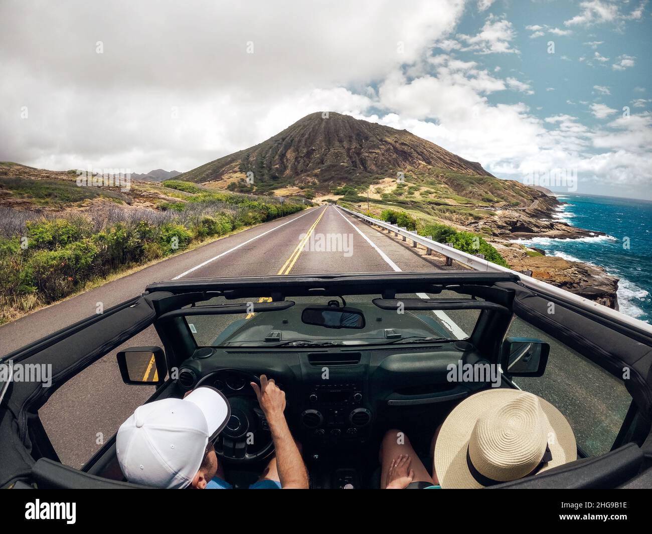 Rear view of a couple driving a convertible car, Lahaina, Maui, Hawaii