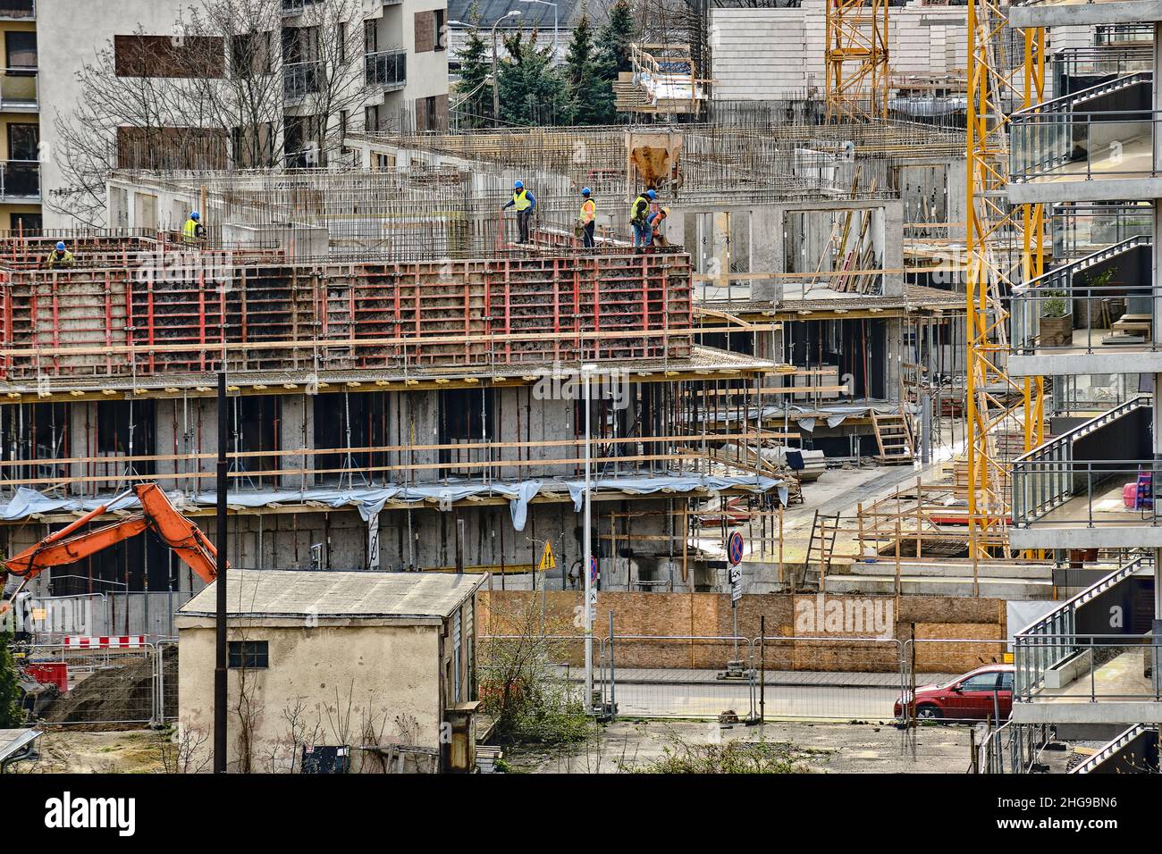 Construction workers install formwork and iron rebars or reinforcing