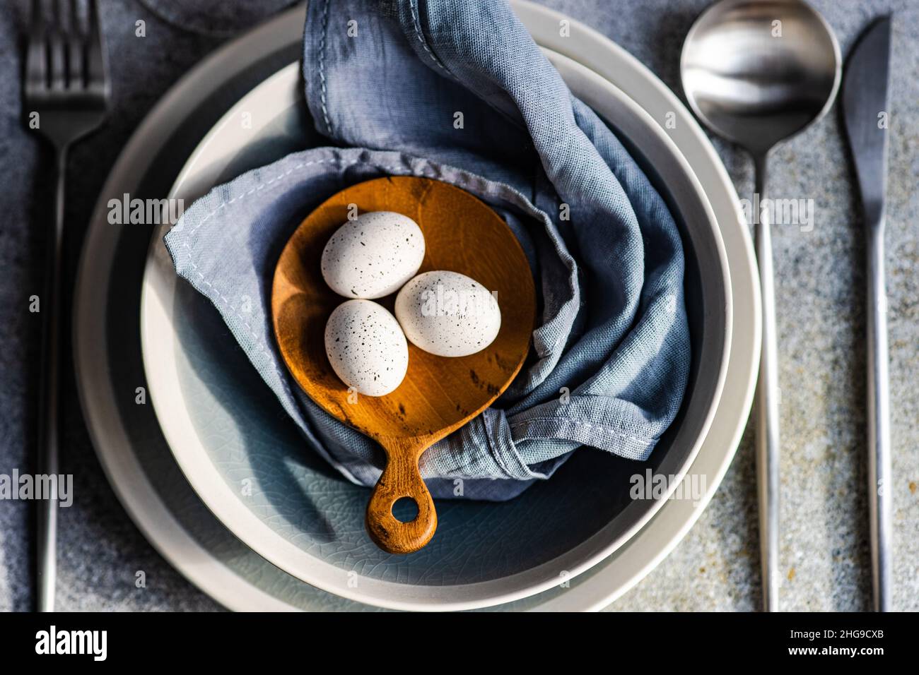 Overhead view of a festive place setting with Easter eggs Stock Photo