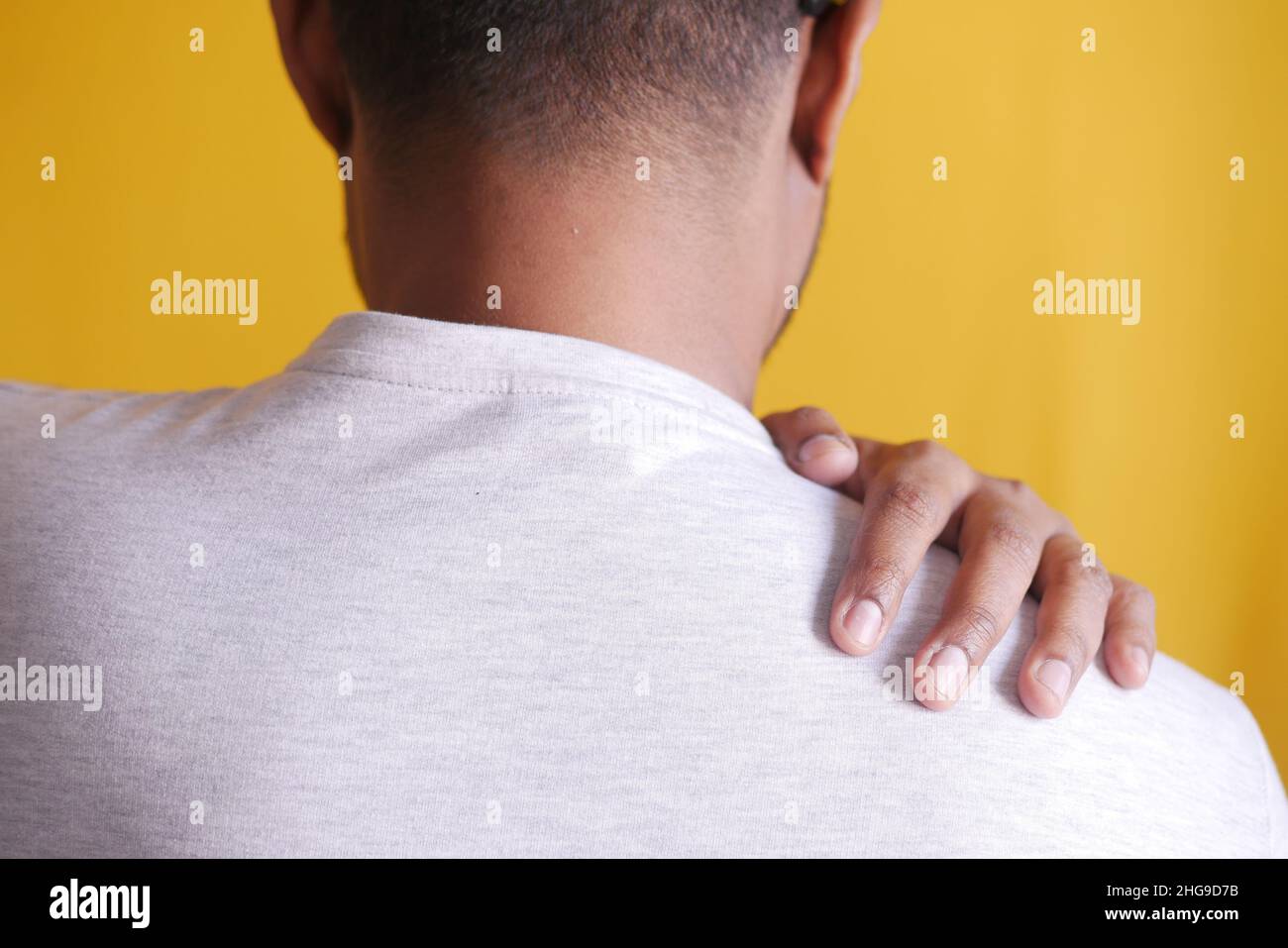 man suffering from neck or shoulder pain at home Stock Photo - Alamy