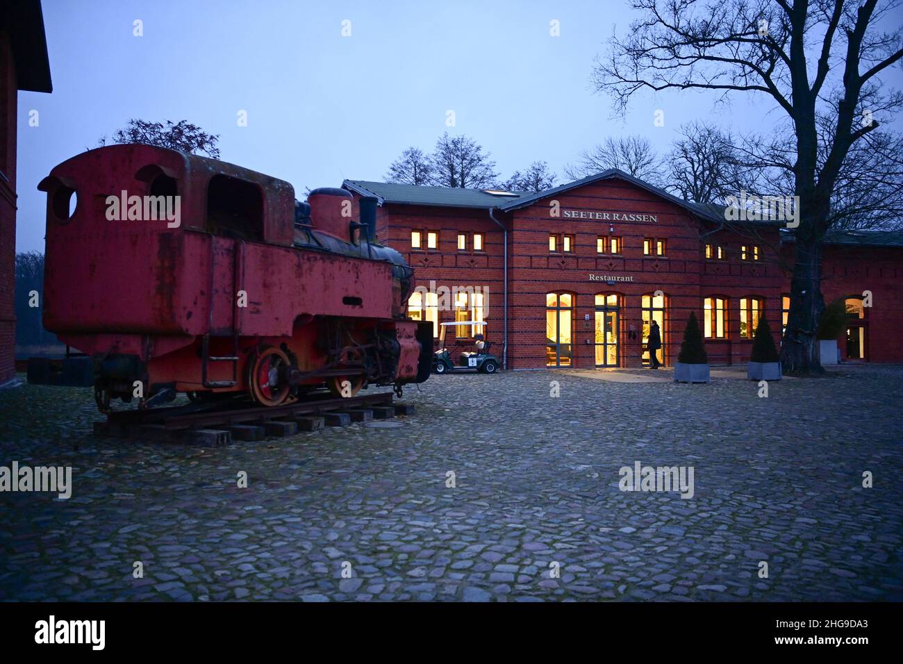 Nauen, Germany. 16th Jan, 2022. A historic steam locomotive stands in the courtyard of Landgut Stober. The former estate of the Borsig family is located on the Groß Behnitzer See lake and was voted the greenest hotel in Europe in 2017 and 2021 according to its own information. The conference hotel has 82 double rooms, 172 single rooms (new building) and 20 suites. Credit: Soeren Stache/dpa-Zentralbild/ZB/dpa/Alamy Live News Stock Photo