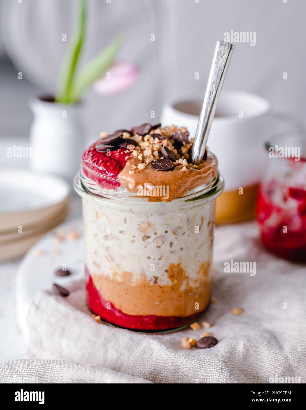 Overnight oats with peanut, butter, jam, chocolate and peanuts Stock