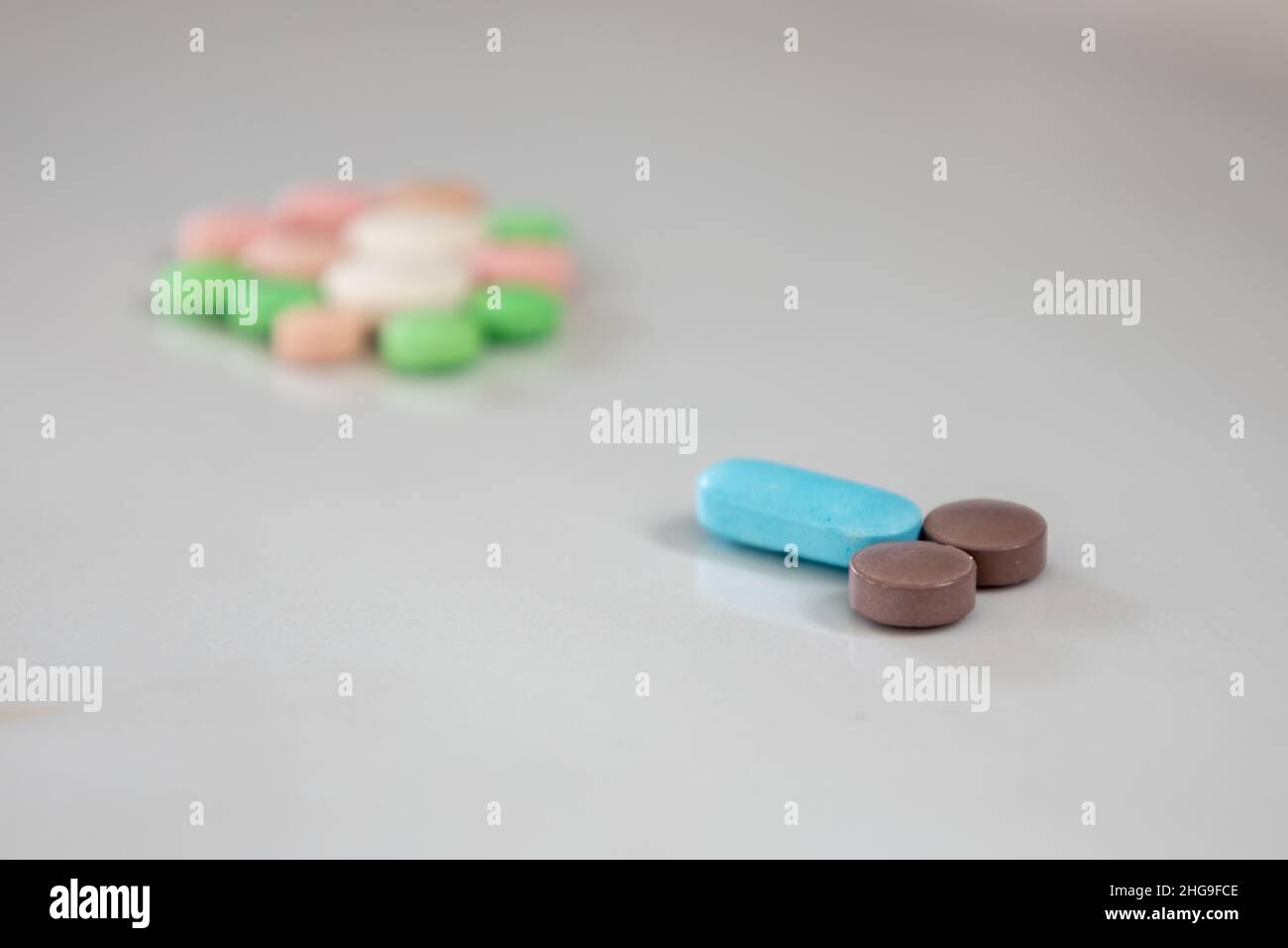 Colored pills simulating male genitalia reaching an egg. Selective focus. Fertility concept. Stock Photo