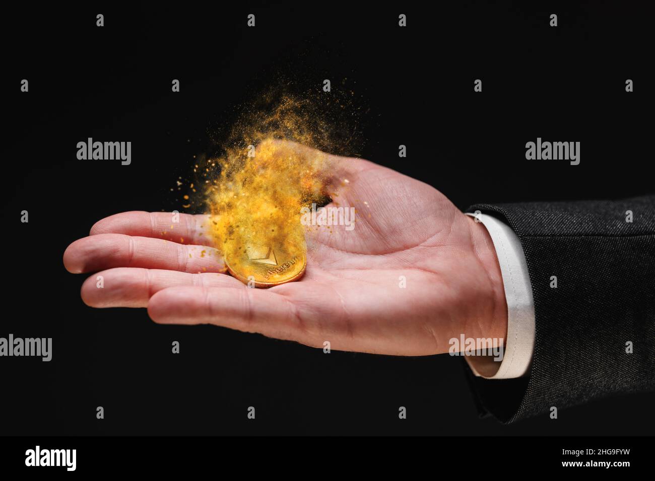 Ethereum cryptocurrency loosing value, investor holding crypto currency dissolving coin in hand, conceptual image with selective focus Stock Photo