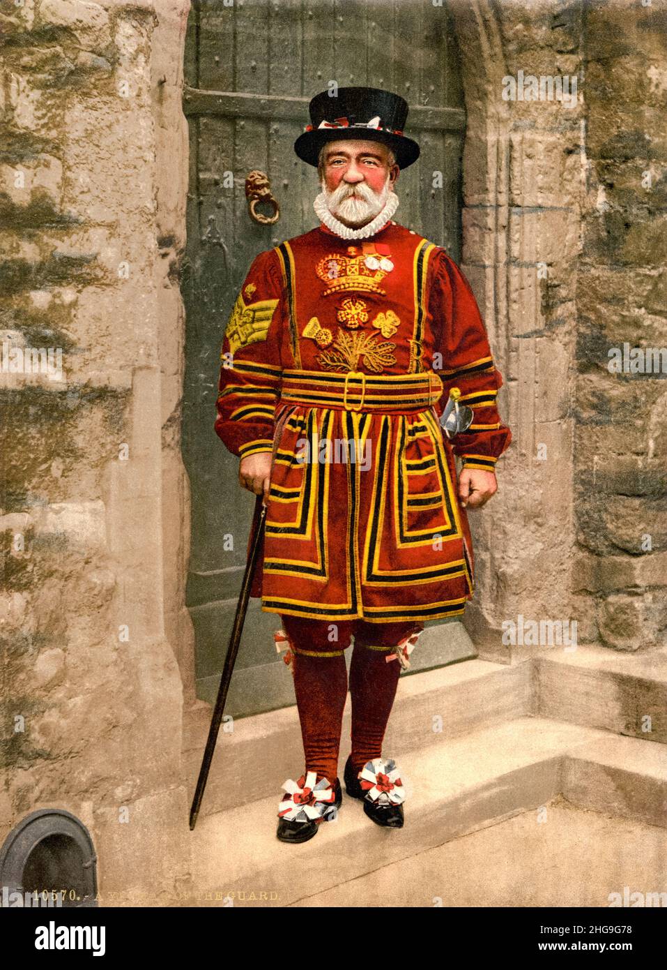 British Yeoman Warder (Beefeater) in Tudor State Dress, (Ceremonial Military Uniform), coloured photograph by Detroit Publishing Co, 1890-1900 Stock Photo