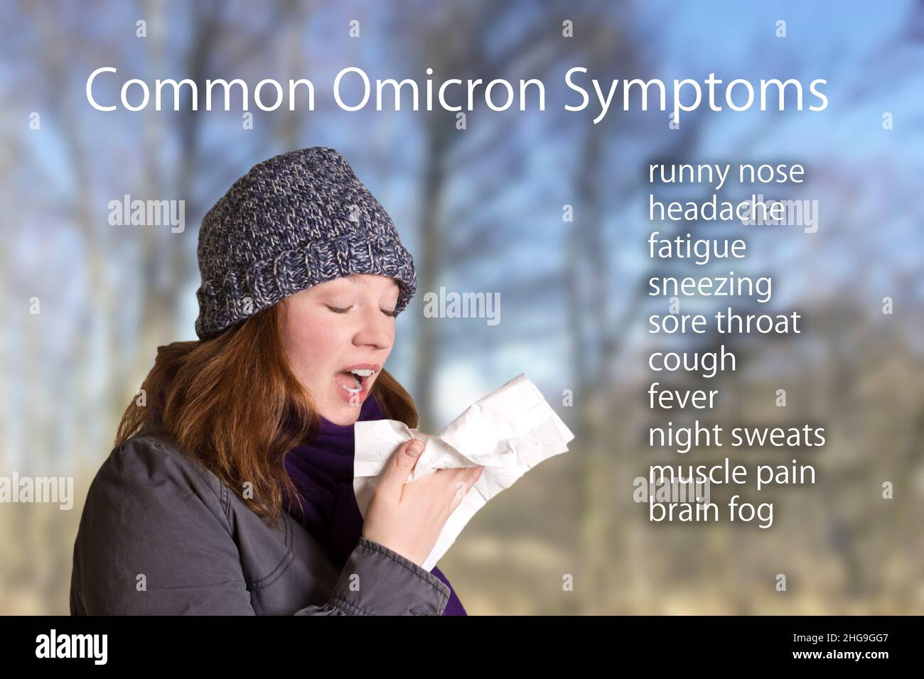 Common symptoms of the covid variant omicron, like runny nose, headache, fatigue and sore throat, text beside a portrait of a young woman sneezing. Stock Photo