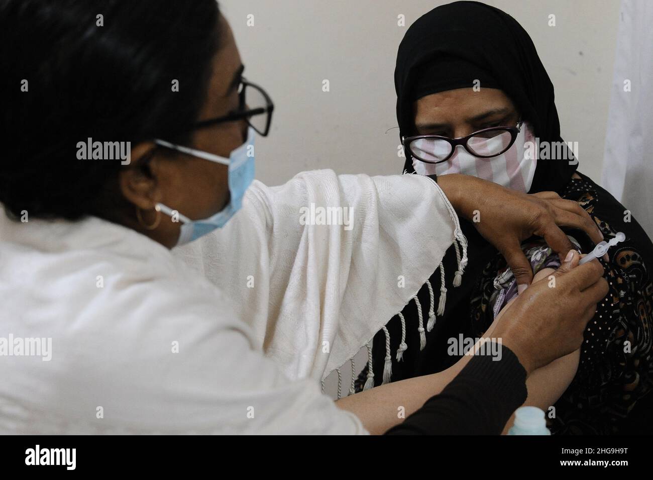 Dhaka, Bangladesh. 19th Jan, 2022. An elderly officially taking the 3rd dose of Covid-19 vaccine at a private clinic in Dhaka. (Photo by Md Saiful Amin/Pacific Press) Credit: Pacific Press Media Production Corp./Alamy Live News Stock Photo