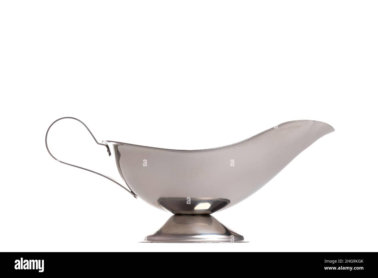 polished stainless steel metal gravy boat with foot on white isolated background Stock Photo