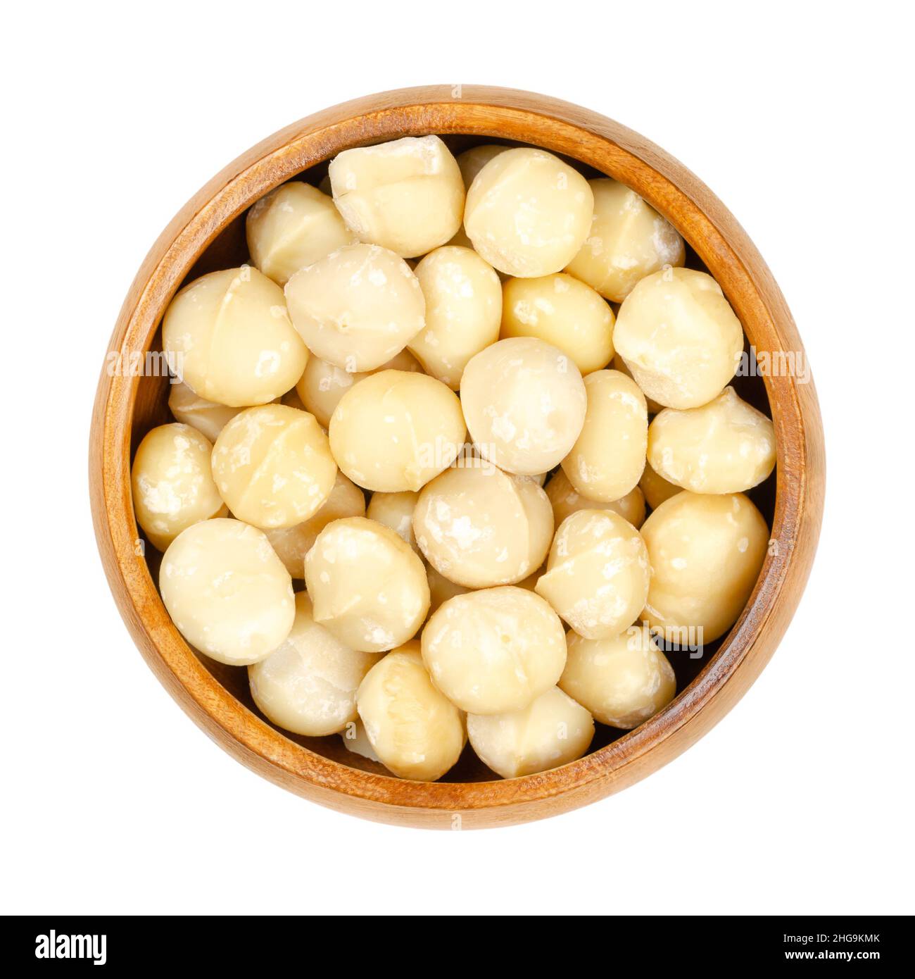 Shelled and dried macadamia nuts, in a wooden bowl. Also called Queensland, bush, maroochi, bauple or Hawaii nut. Wholesome snack. Stock Photo