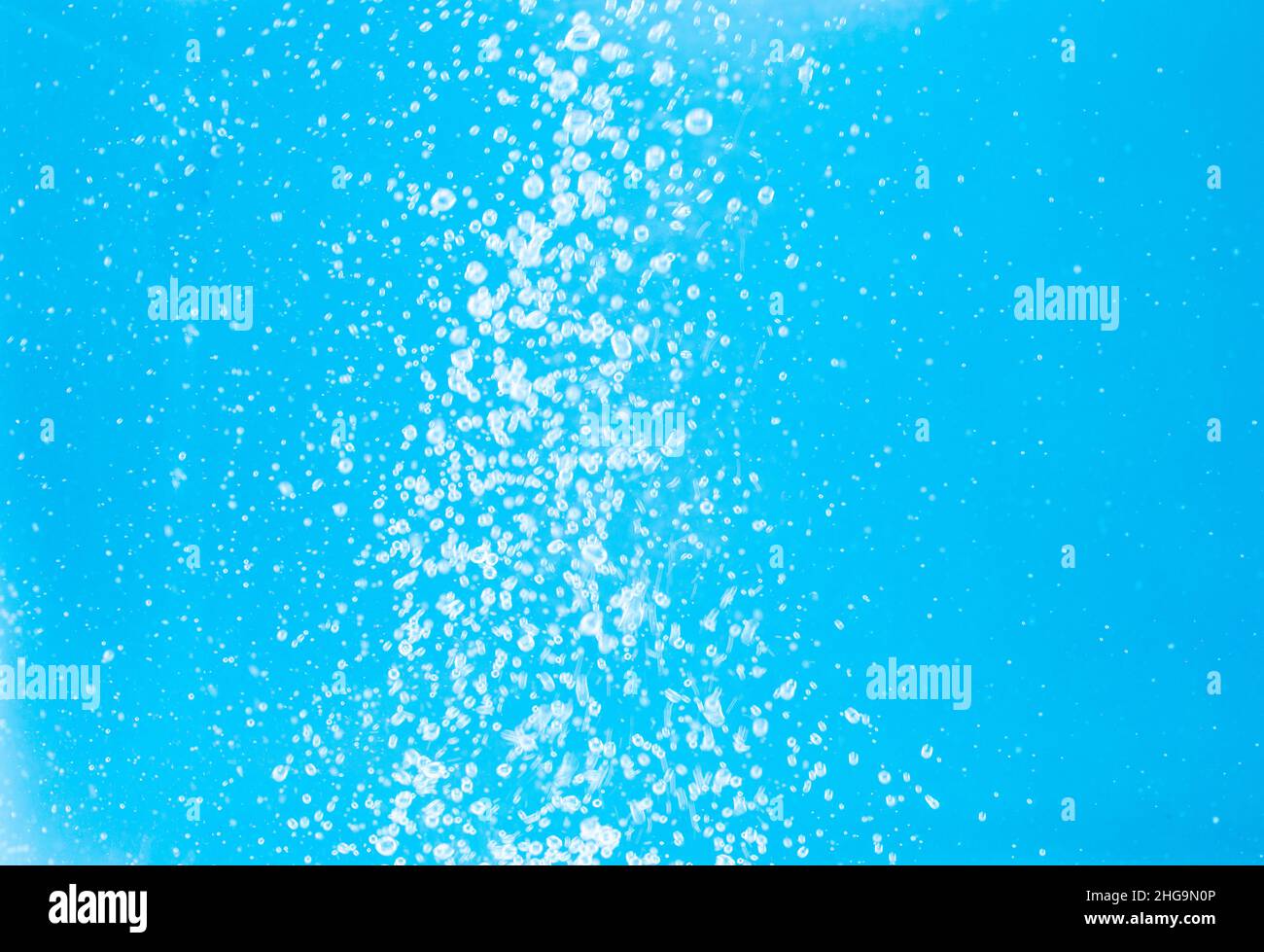 Blue background with transparent bubbles of air floating in the water ...
