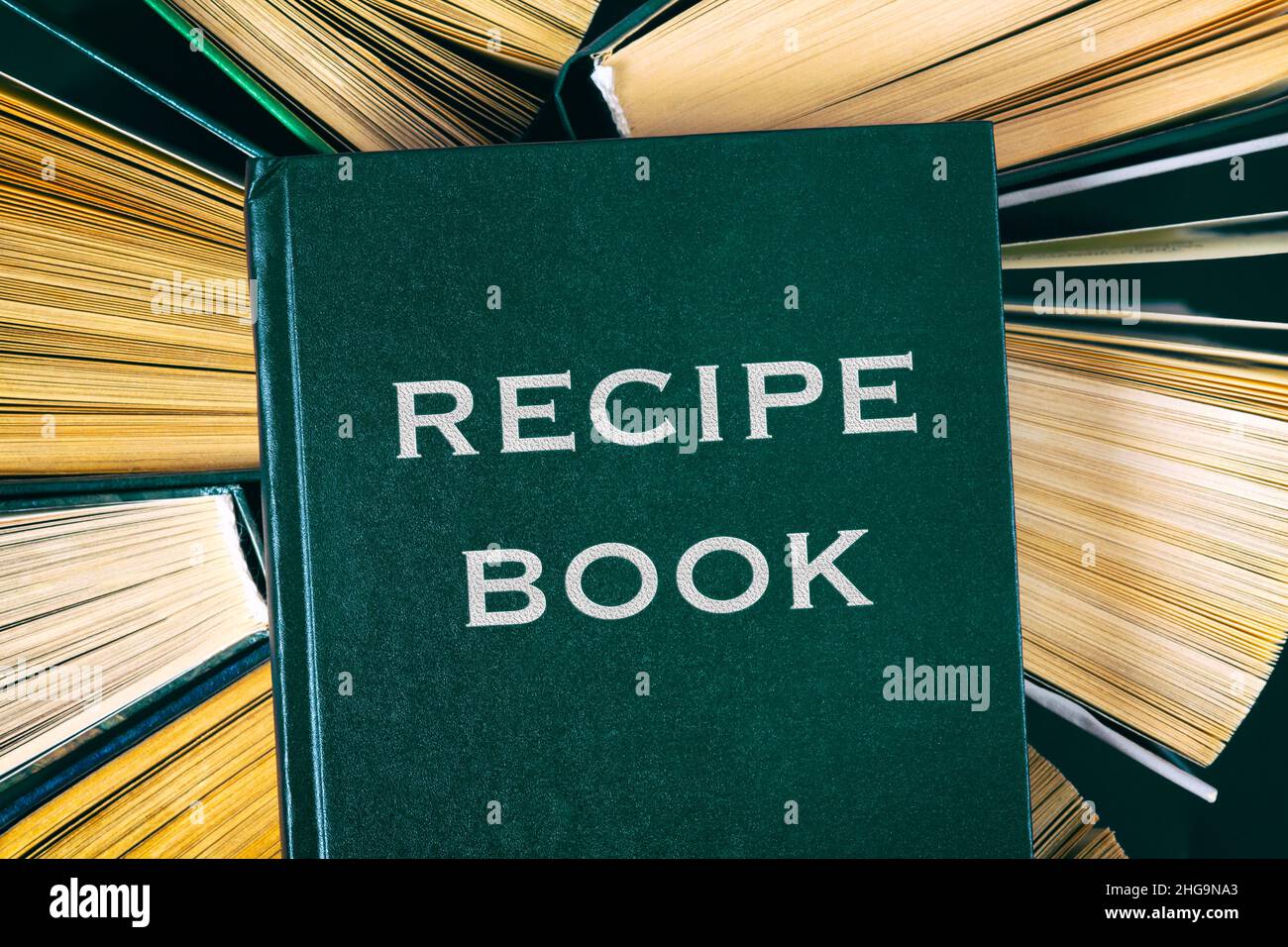 Top view of old hardcover books with Recipe Book on top. Stock Photo