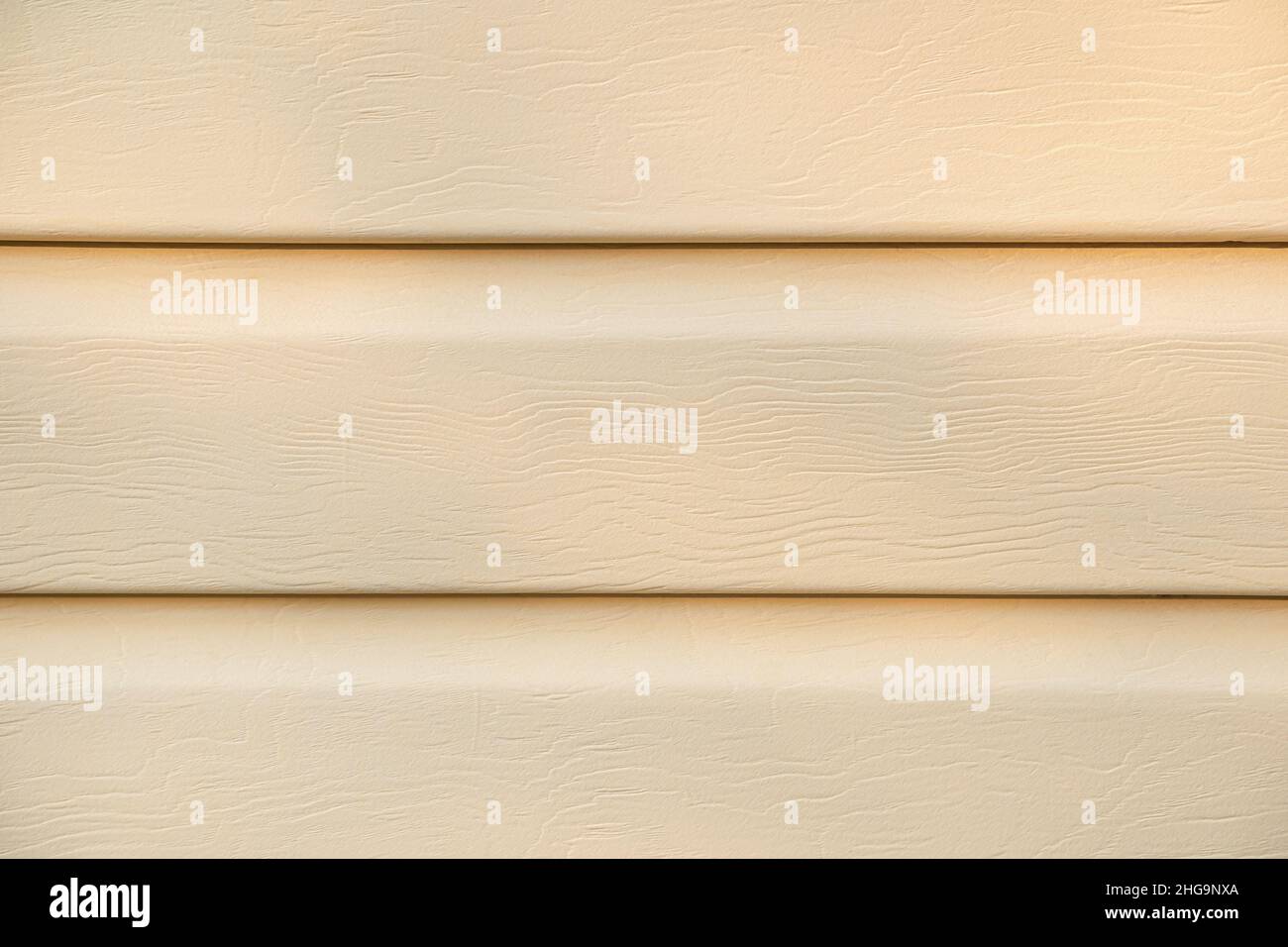Textured beige siding background. Beige sheathing material for houses