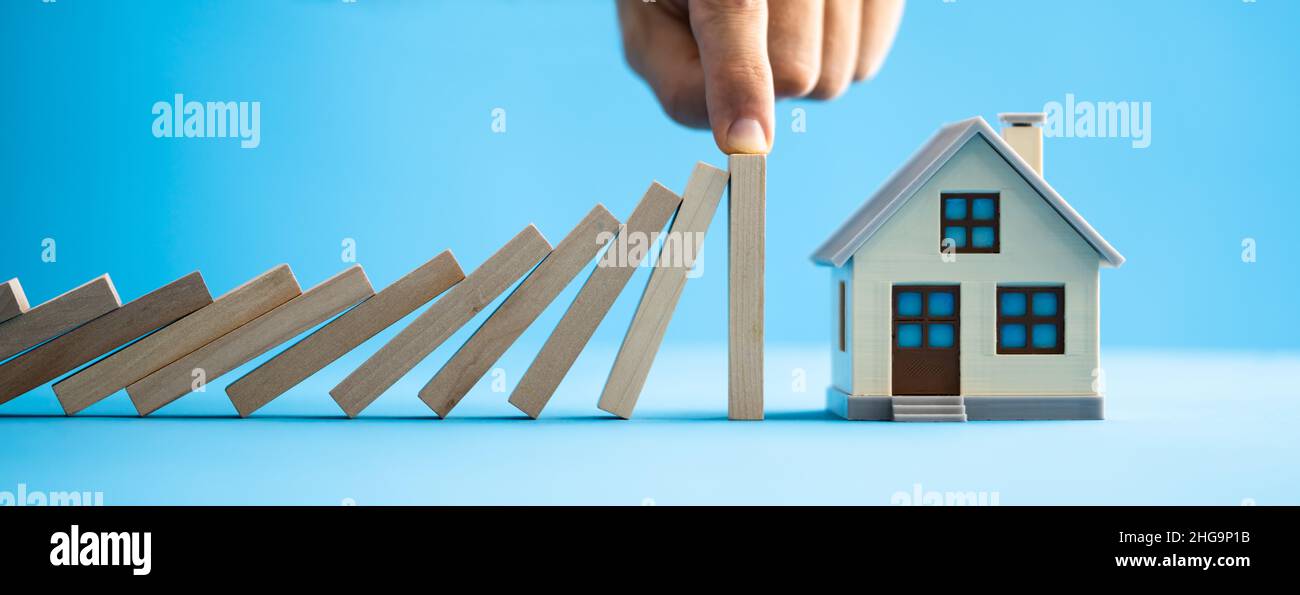 Real Estate House Insurance. Domino Chain Challenge And Risk Protection Stock Photo