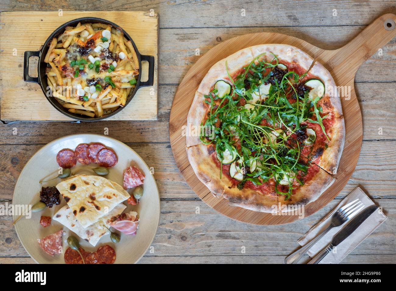 Delicious artisan pizza, healthy wrap and feta cheese salad shot from above Stock Photo
