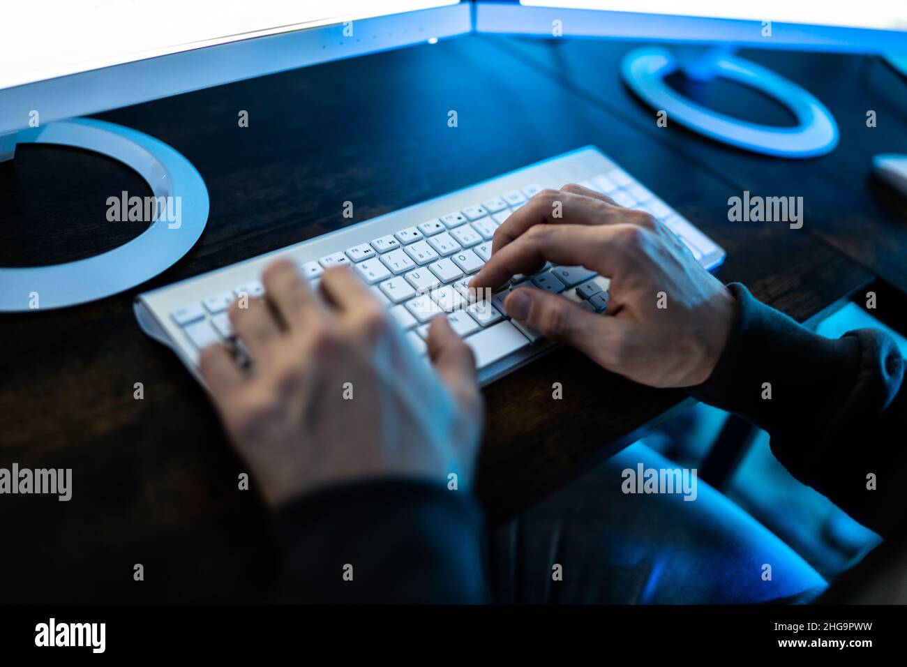 Male Hacker Stealing Data From Computer In Office Stock Photo