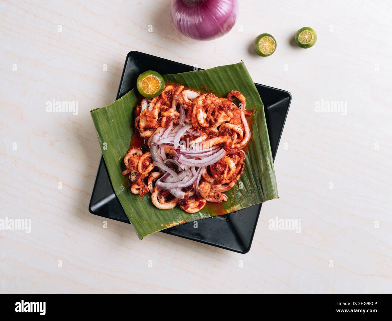 Korean BBQ squid calamary with raw onion and lemon Traditional korean